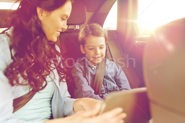 happy family with tablet pc driving in car Stock photo © dolgachov