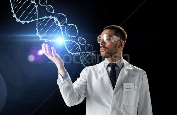 scientist in lab coat and safety glasses with dna Stock photo © dolgachov