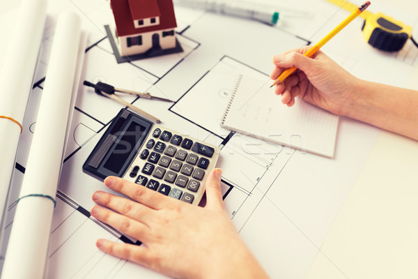 Stock photo: close up of architect hand counting on calculator