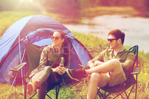 happy couple drinking beer at campsite tent Stock photo © dolgachov