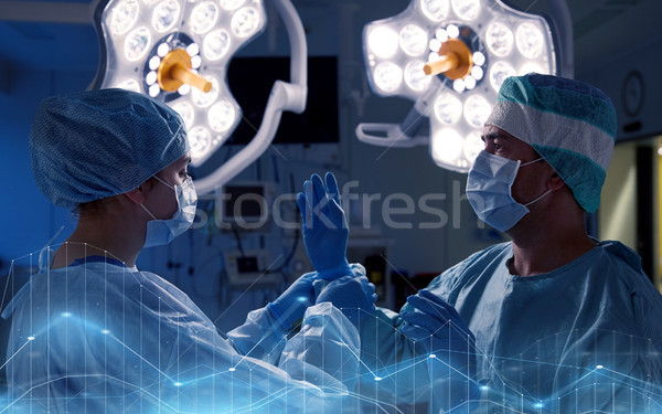 surgeons in operating room at hospital Stock photo © dolgachov