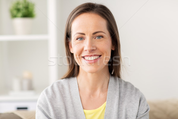 happy smiling middle aged woman at home Stock photo © dolgachov