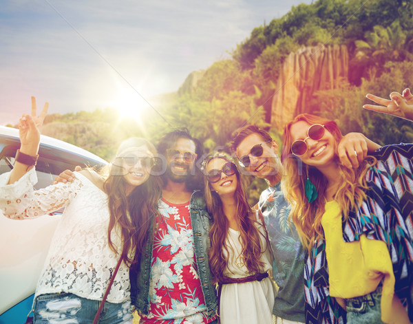 hippie friends at minivan car showing peace sign Stock photo © dolgachov
