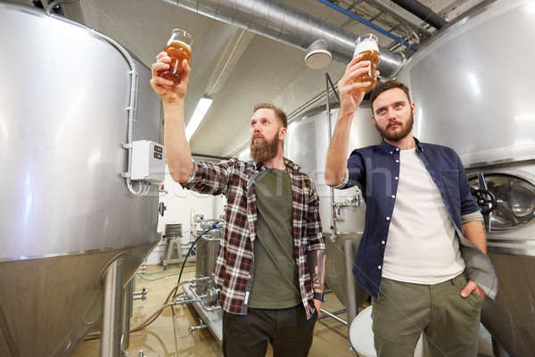 men testing non-alcoholic craft beer at brewery Stock photo © dolgachov