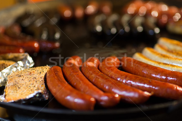 Stock photo: sausages and salmon frying in stir fry pan