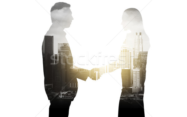 business people shaking hands over city background Stock photo © dolgachov