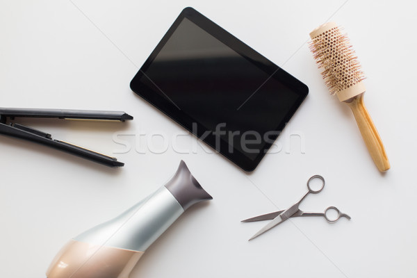 tablet pc, scissors, hairdryer, hot iron and brush Stock photo © dolgachov