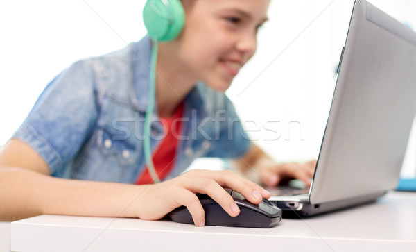 boy in headphones playing video game on laptop Stock photo © dolgachov