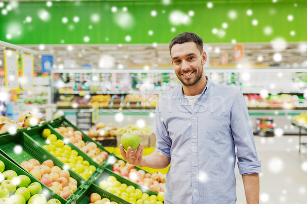 happy man buying green apples at grocery store Stock photo © dolgachov