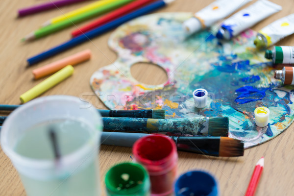 palette, brushes and paint tubes on table Stock photo © dolgachov