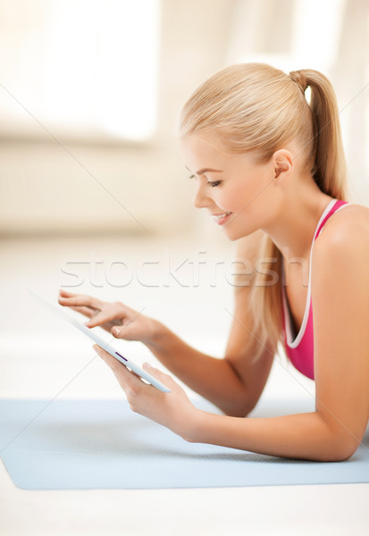woman lying on the floor with tablet pc Stock photo © dolgachov
