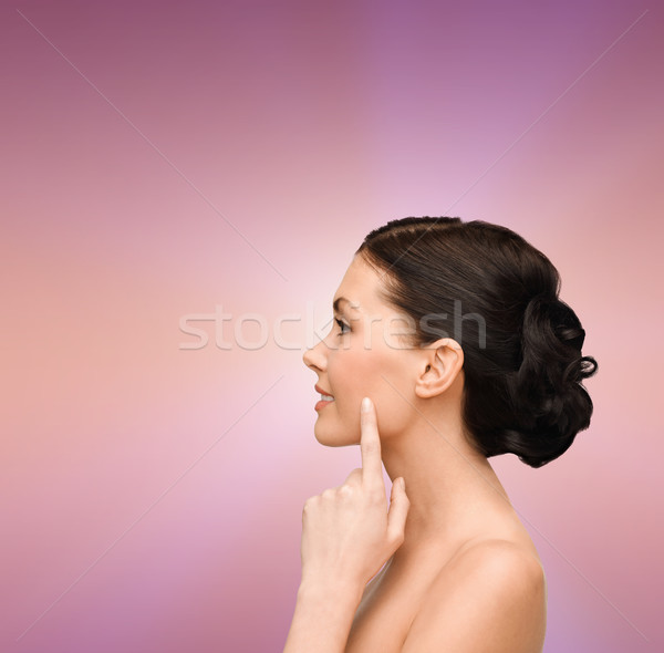 Uśmiechnięty młoda kobieta wskazując policzek zdrowia Zdjęcia stock © dolgachov
