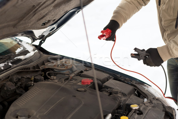 closeup of man under bonnet with starter cables Stock photo © dolgachov