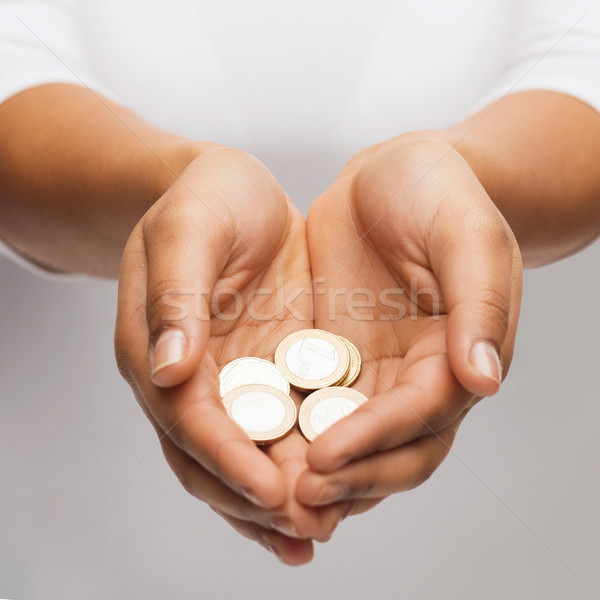 womans cupped hands showing euro coins Stock photo © dolgachov