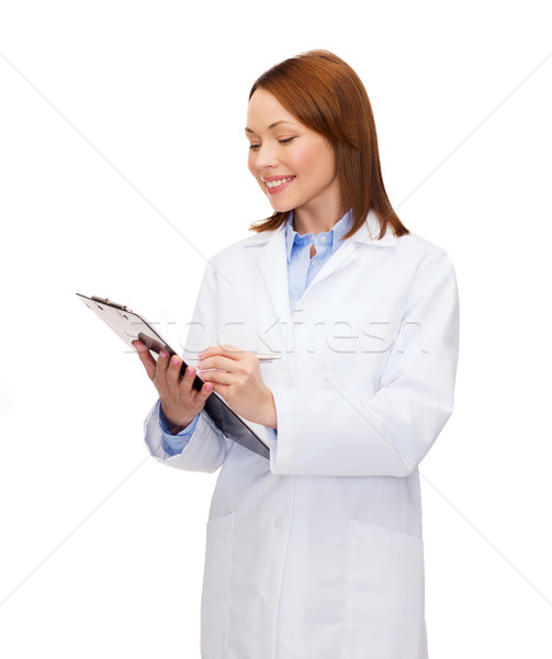 smiling female doctor with clipboard Stock photo © dolgachov