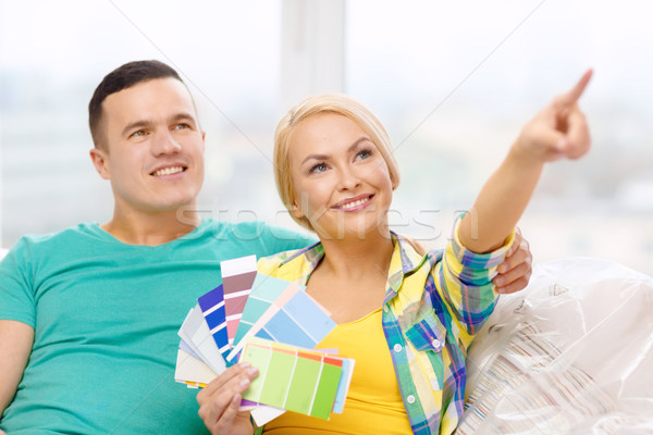 Stock photo: couple looking at color samples in new home