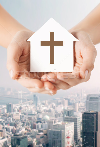 close up of hands and paper house with cross Stock photo © dolgachov