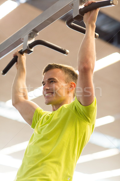 smiling man exercising in gym Stock photo © dolgachov