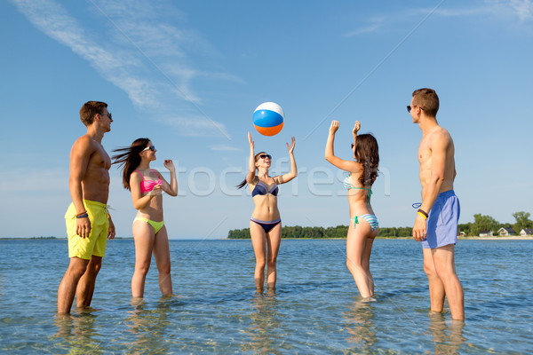 smiling friends in sunglasses on summer beach Stock photo © dolgachov