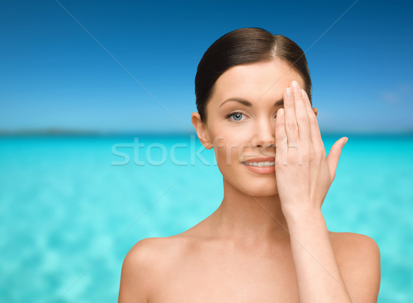 smiling young woman covering face with hand Stock photo © dolgachov