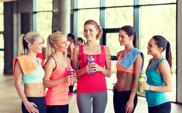 women with bottles of water in gym Stock photo © dolgachov
