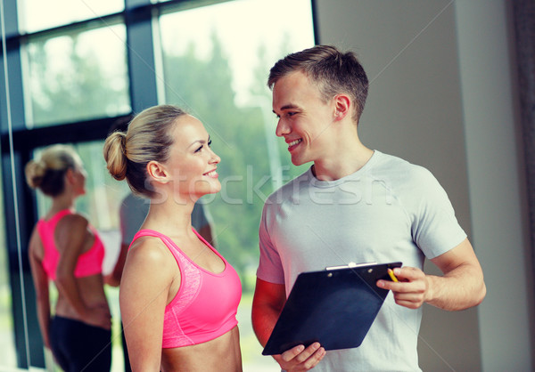 Mosolyog fiatal nő személyi edző tornaterem fitnessz sport Stock fotó © dolgachov