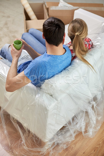 happy couple relaxing on sofa in new home Stock photo © dolgachov