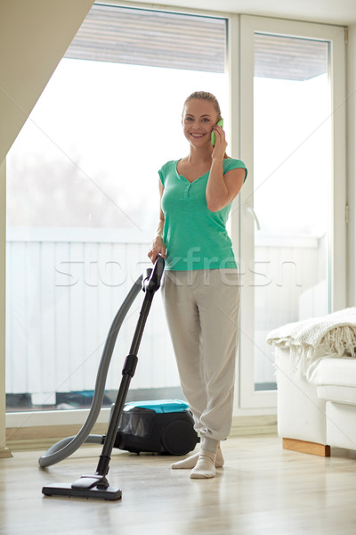 happy woman with vacuum cleaner at home Stock photo © dolgachov
