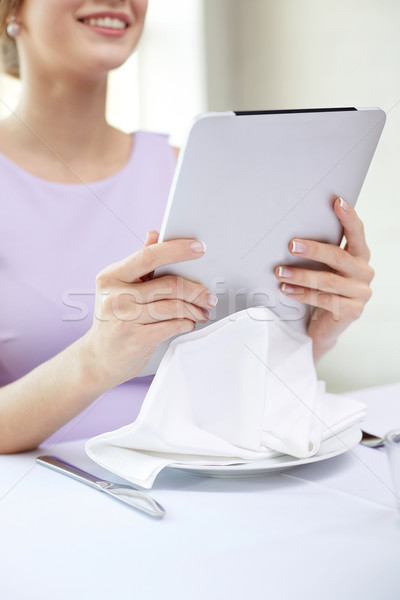 close up of woman with tablet pc at resturant Stock photo © dolgachov