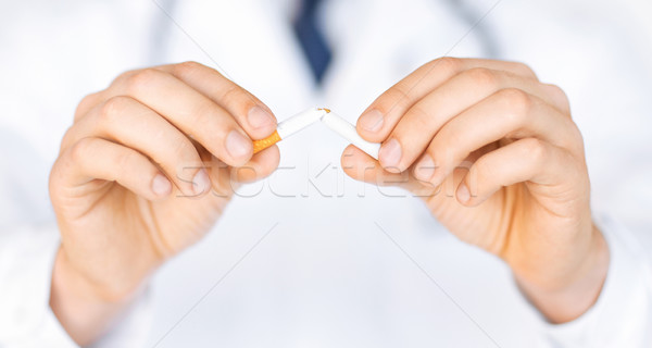 man breaking the cigarette with hands Stock photo © dolgachov
