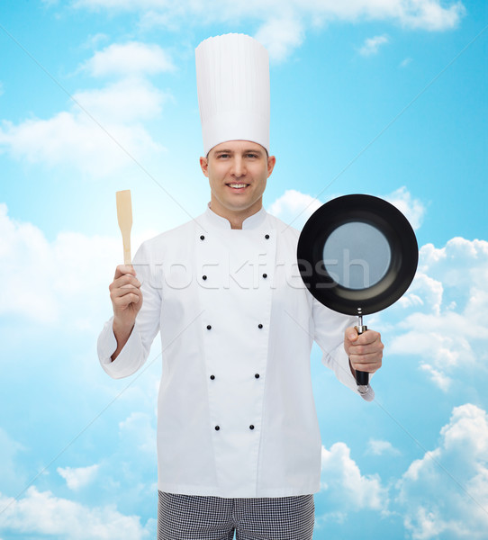 happy male chef holding frying pan and spatula Stock photo © dolgachov