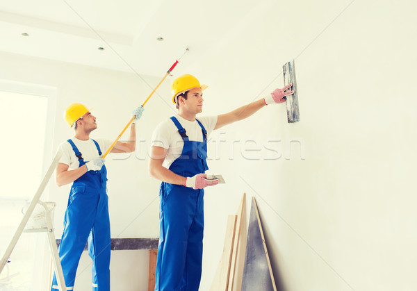 group of builders with tools indoors Stock photo © dolgachov