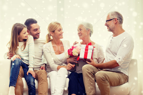 Stock photo: happy family with bunch and gift box at home
