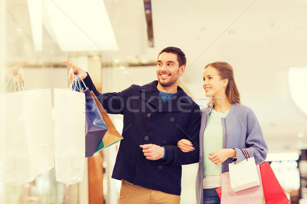 happy young couple with shopping bags in mall Stock photo © dolgachov