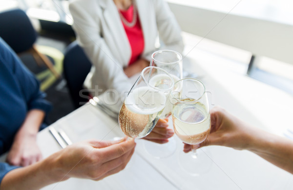 close up of women clinking champagne at restaurant Stock photo © dolgachov