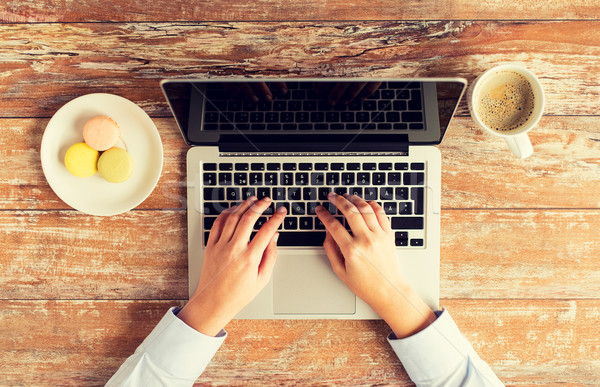 Stock photo: close up of female hands with laptop and coffee