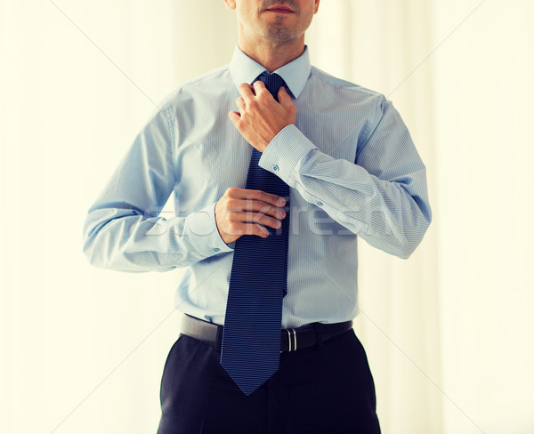 close up of man in shirt adjusting tie on neck Stock photo © dolgachov