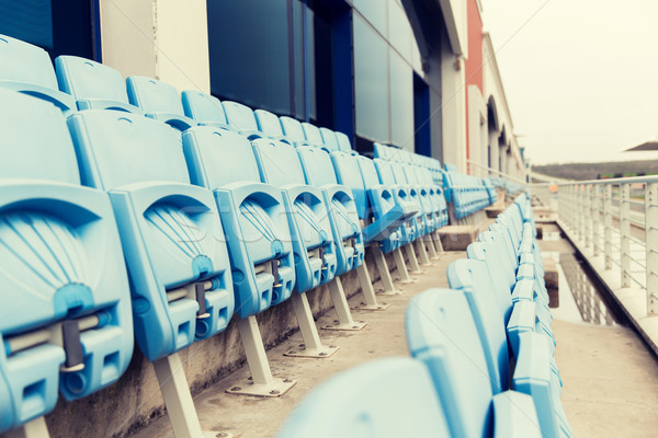 rows with folded seats of bleachers on stadium Stock photo © dolgachov