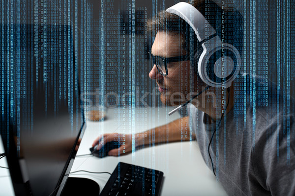 man in headset playing computer video game at home Stock photo © dolgachov