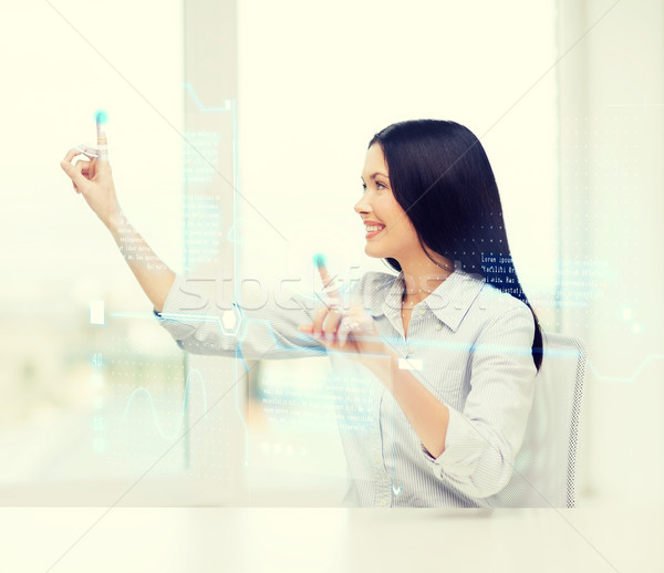 smiling woman pointing to virtual screen Stock photo © dolgachov