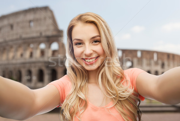 happy smiling young woman taking selfie Stock photo © dolgachov