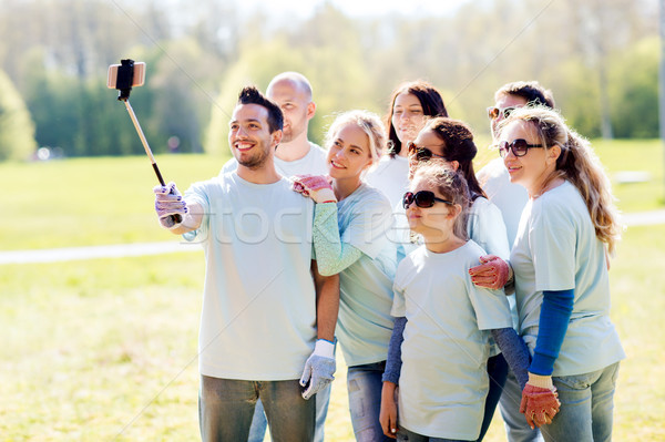 group of volunteers taking smartphone selfie Stock photo © dolgachov