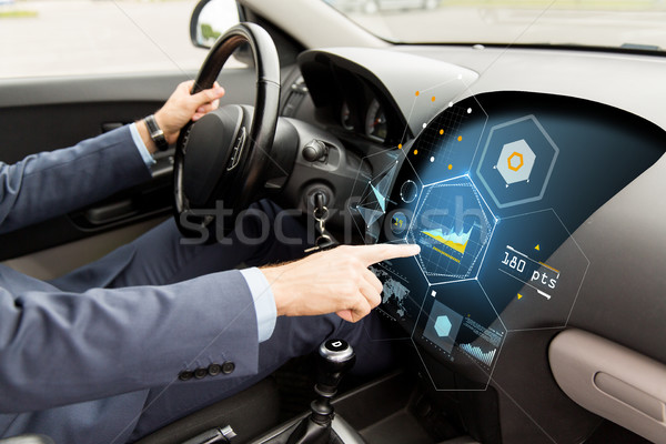 close up of man driving car with diagram on screen Stock photo © dolgachov
