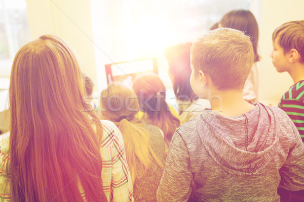 Stock photo: group of kids with teacher and computer at school