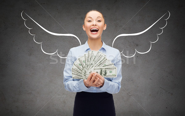Empresária dólar dinheiro asas de anjo negócio Foto stock © dolgachov