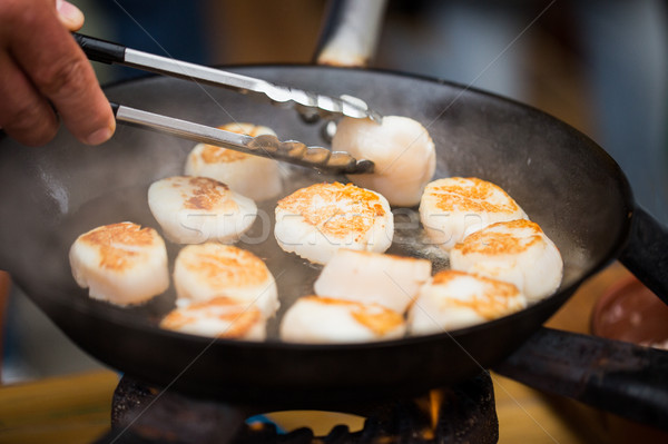 close up of scallops frying in cast iron pan Stock photo © dolgachov