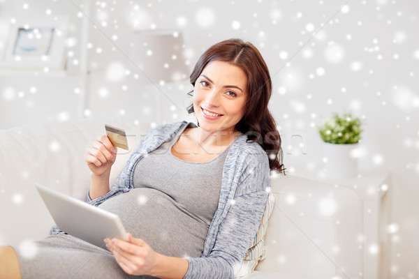 pregnant woman with tablet pc and credit card Stock photo © dolgachov