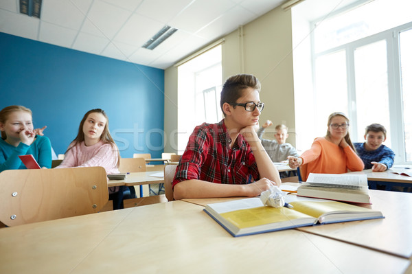 classmates laughing at student boy in school Stock photo © dolgachov