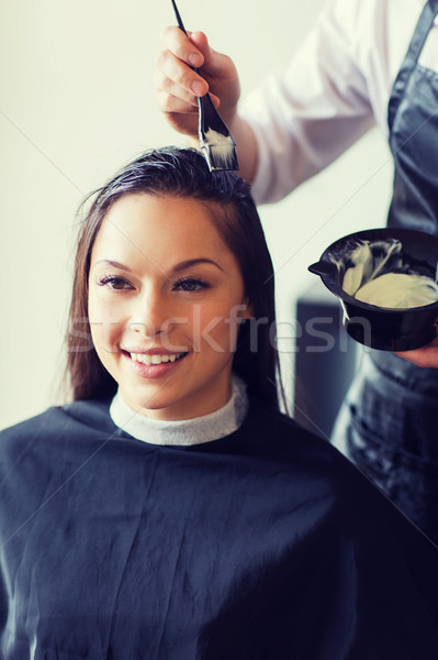 happy woman with stylist coloring hair at salon Stock photo © dolgachov