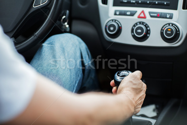 close up of man driving car and using gear shift Stock photo © dolgachov